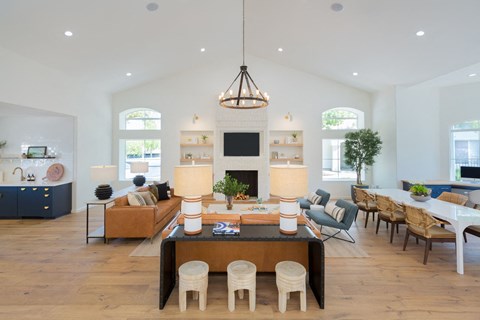 a large living room with a table and chairs